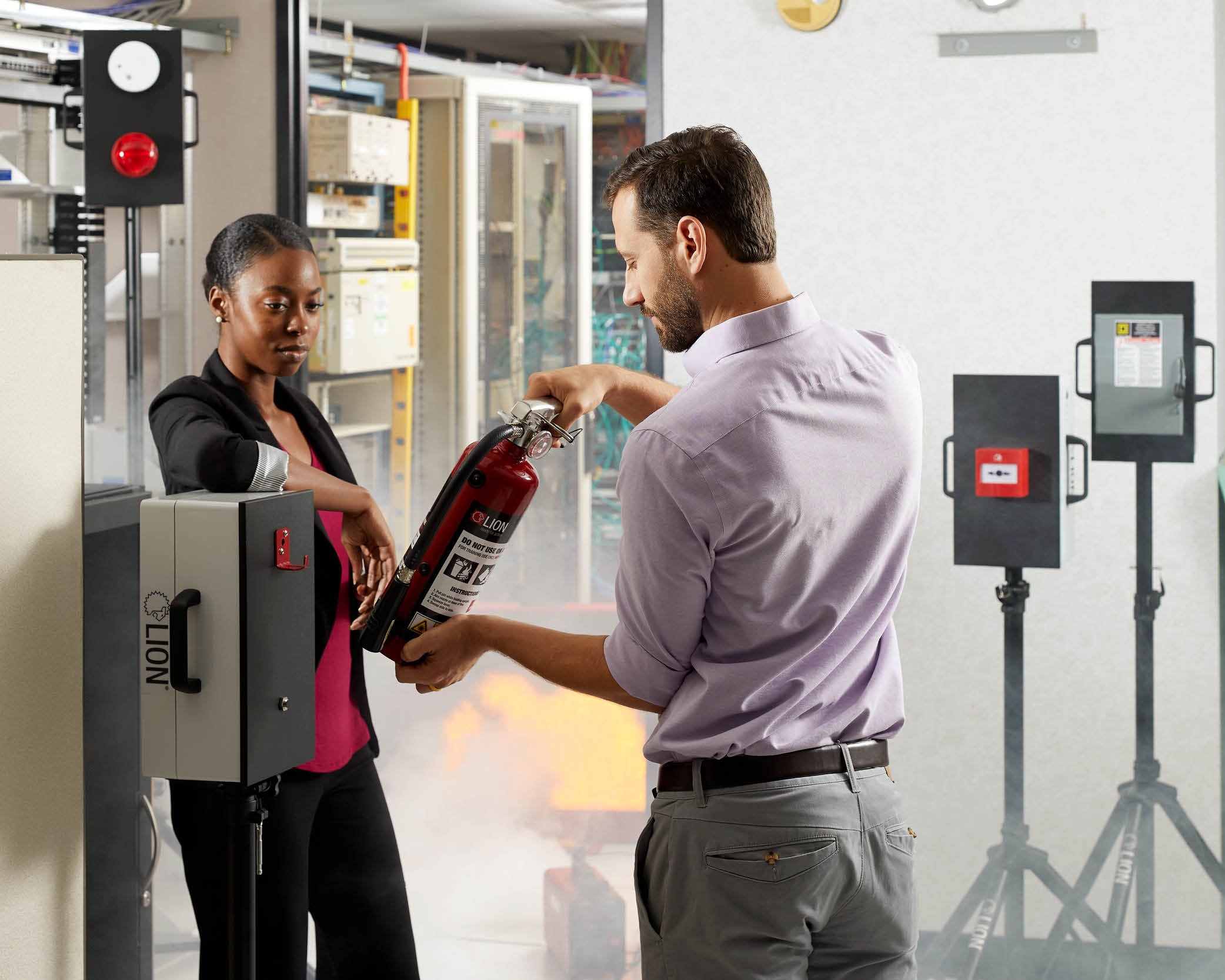 Office-team-using-fire-extinguisher-on-LION-RACE-Station-in-server-room